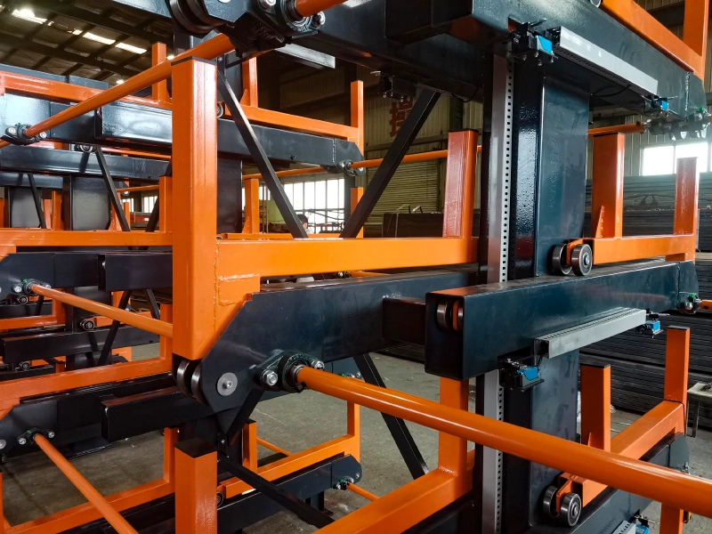 Close-up of telescopic cantilever rack with roller-supported steel arms and welded frame