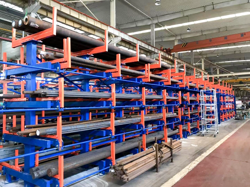 Dense multi-tier telescopic cantilever rack holding long steel bars in a metal service center