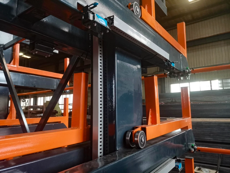 Close-up of a telescopic cantilever rack arm with roller-guided steel contact for scratch-free alloy tube storage
