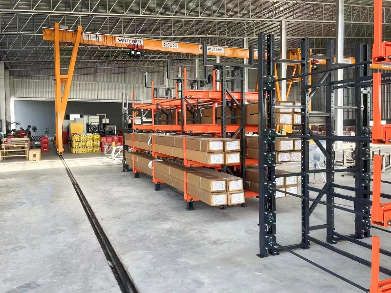 Single-sided telescopic cantilever rack storing wrapped long material bundles on orange steel arms