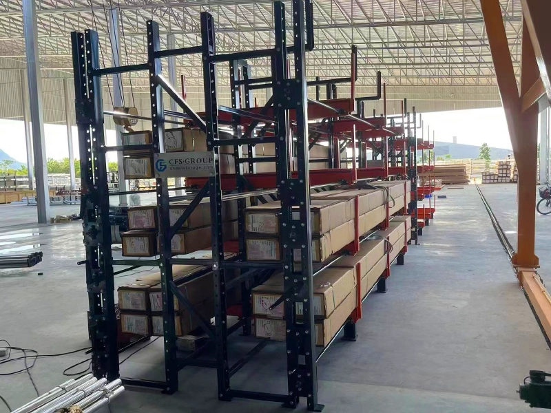 Dense telescopic cantilever racking storing long steel bars by size in a steel service center