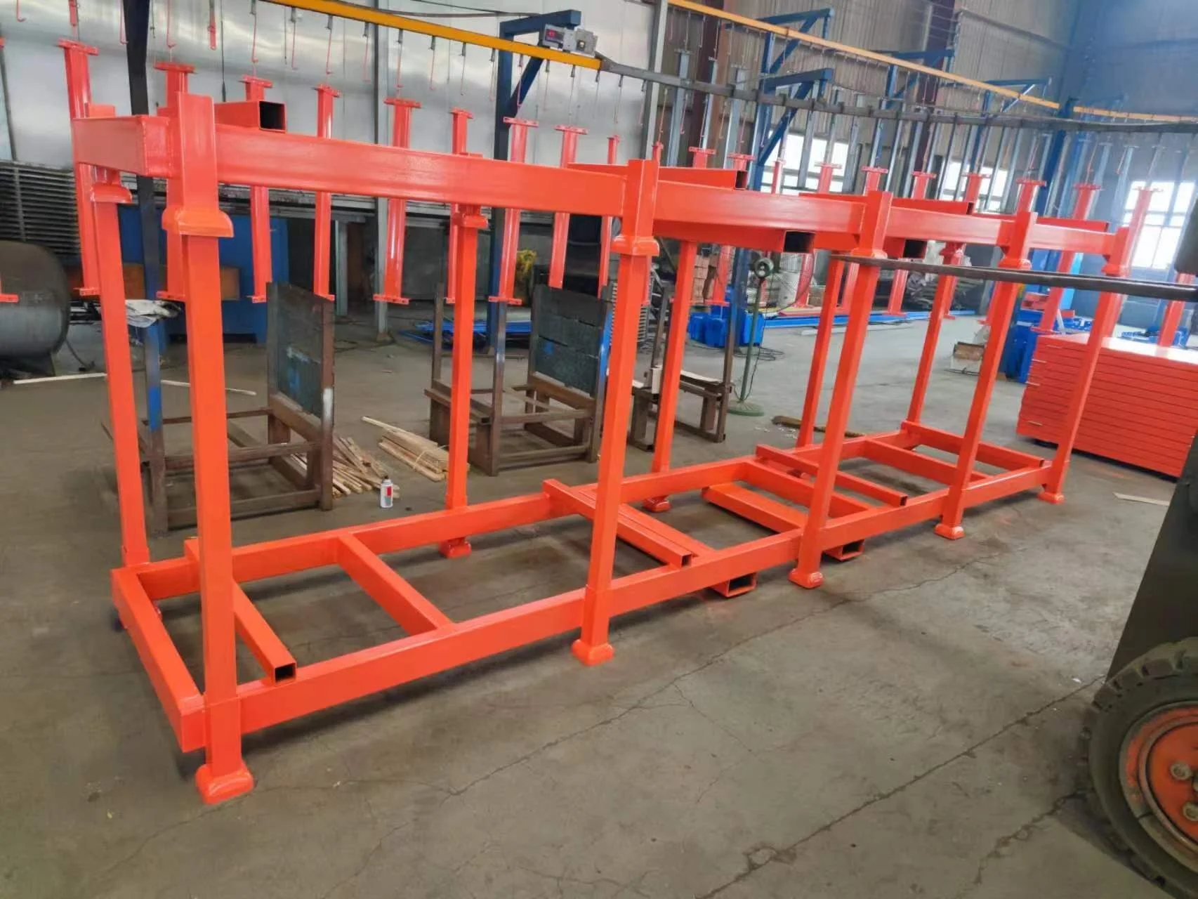 Stack of blue powder-coated portable stack racks wrapped for shipment