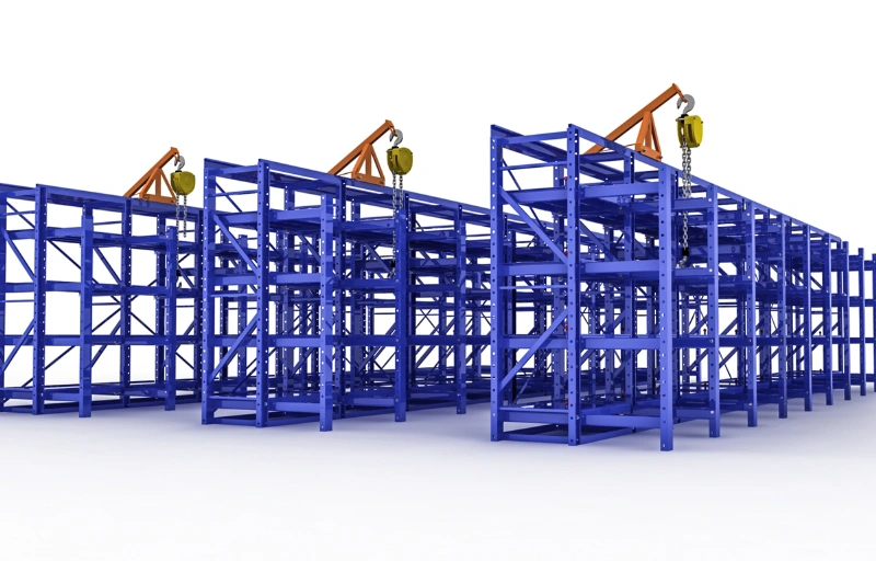 Blue three-column roll-out mold racks with overhead jib crane and chain hoists