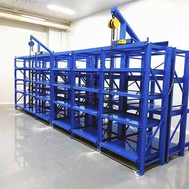 Blue roll-out mold rack with overhead chain hoists and epoxy floor anchoring