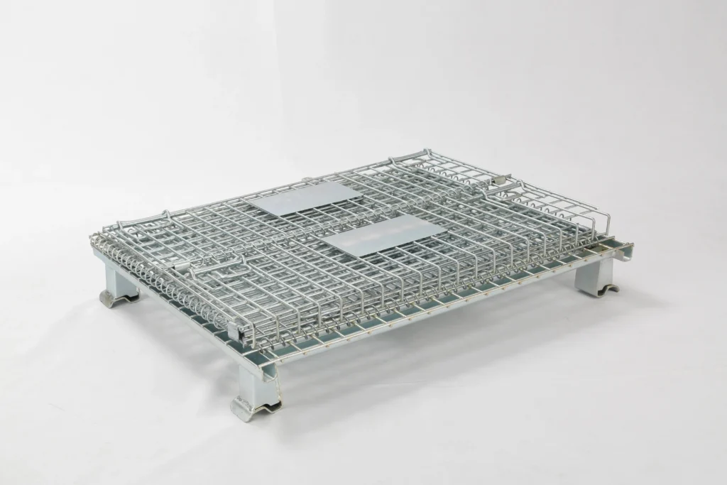 Collapsed galvanized steel wire mesh container in flat-folded configuration for space-saving empty storage.