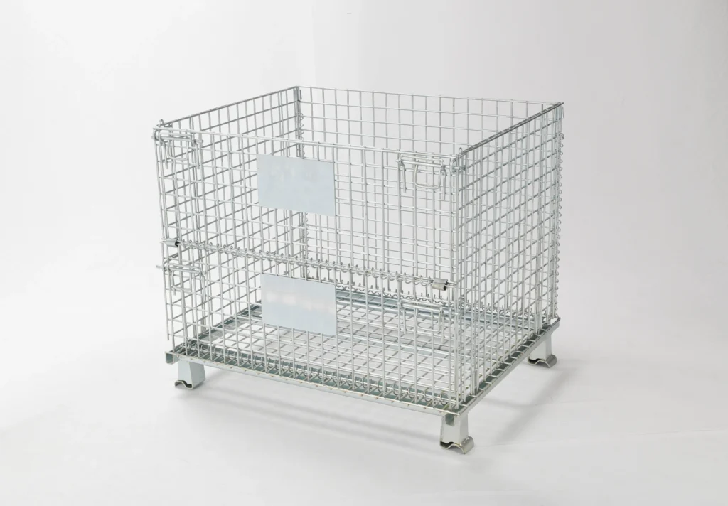Rear angle of galvanized collapsible steel stillage box showing helical hinges and dual product identifier plates.