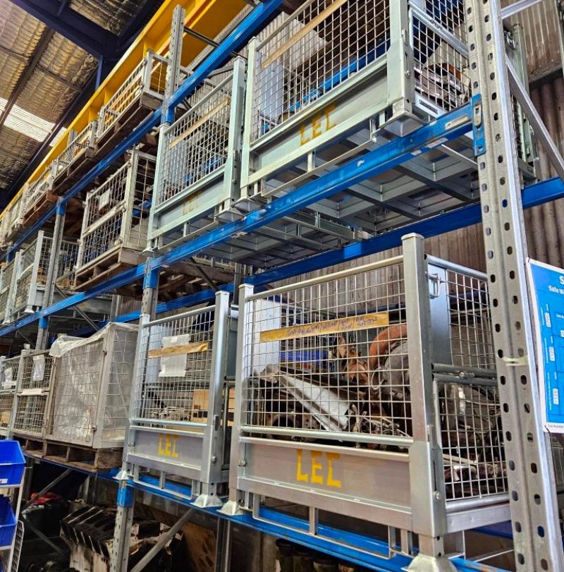 Galvanized wire containers spray-painted with "LEC" stored on warehouse racks