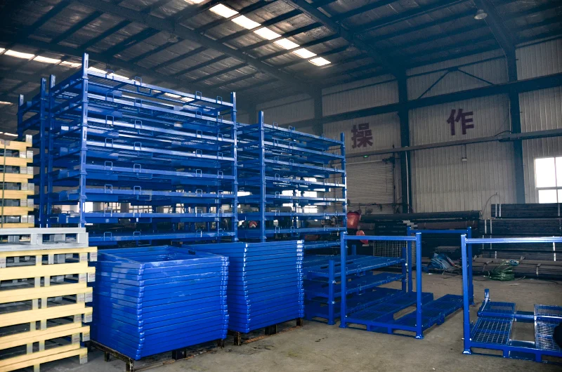 Blue powder coated steel stackable pallet racks with mesh decks and corner posts in warehouse
