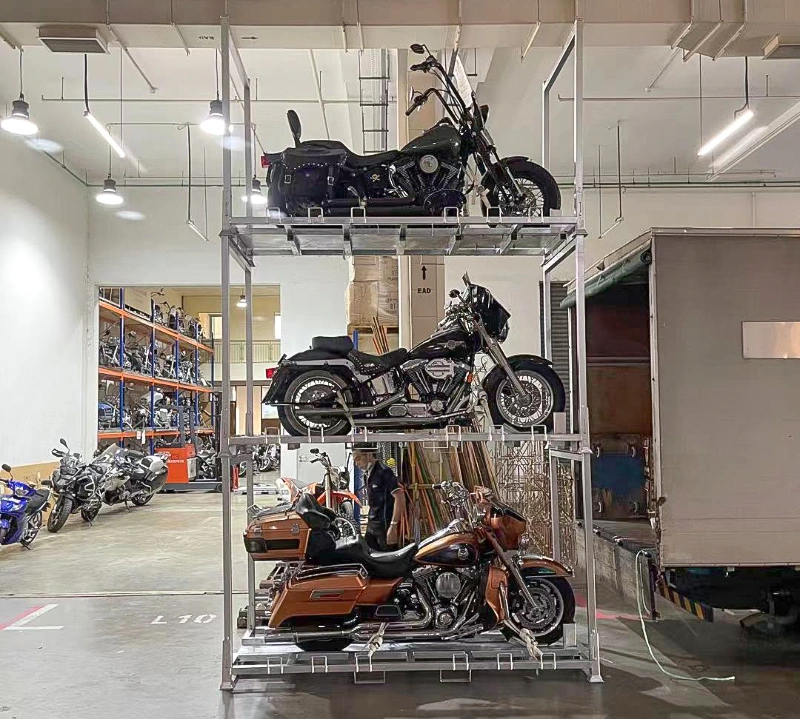 Three-tier stackable steel motorcycle racking system holding cruiser bikes in a warehouse facility