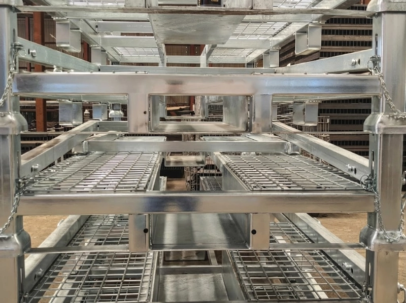 Close-up of hot-dip galvanized steel motorcycle pallet rack with wire mesh deck and safety pin chain