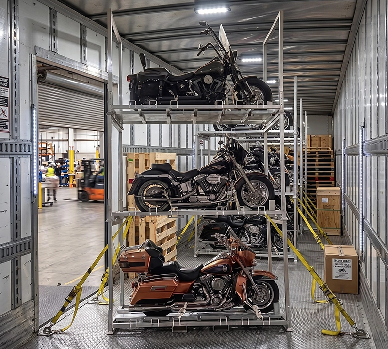 Steel motorcycle pallet rack with multi-tier stacking storage, wheel chocks, and tie-down straps