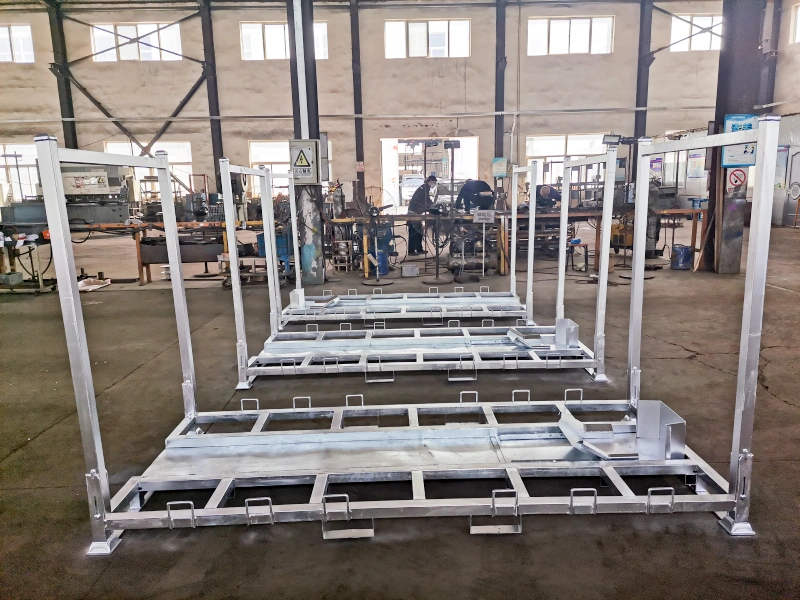Row of silver steel motorcycle transport racks in factory highlighting bolt-on feet and forklift channels