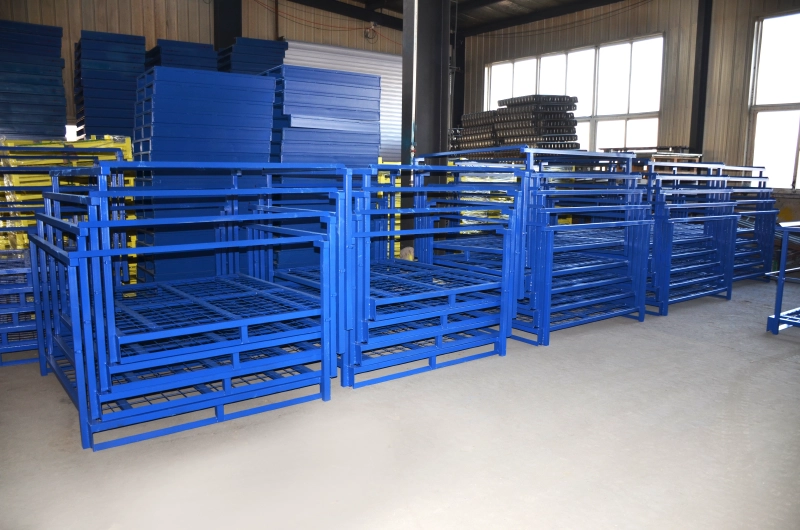 Multiple rows of empty blue steel nestainer racks nested together on a factory floor to save storage space