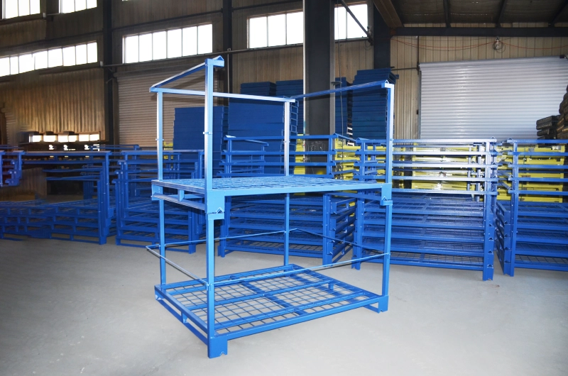 Two empty blue steel nestainer racks stacked on top of each other showing stacking cup mechanism in workshop
