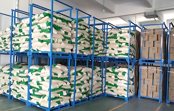 Two level stacked blue steel nestainer racks holding paper valve bags and cardboard boxes in a clean warehouse