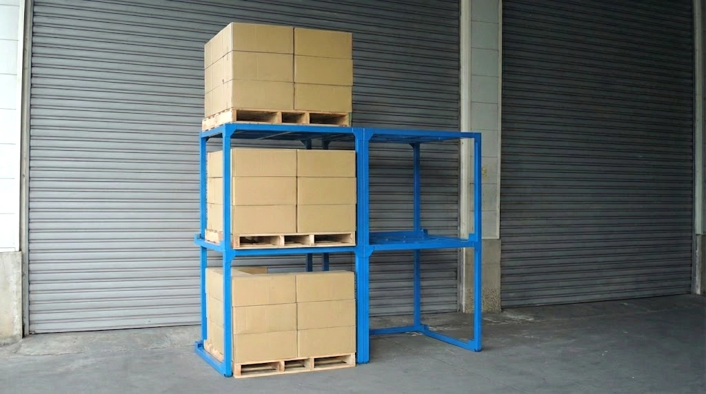 Blue steel stack rack loaded with palletized cartons in a warehouse, showing three-tier vertical storage