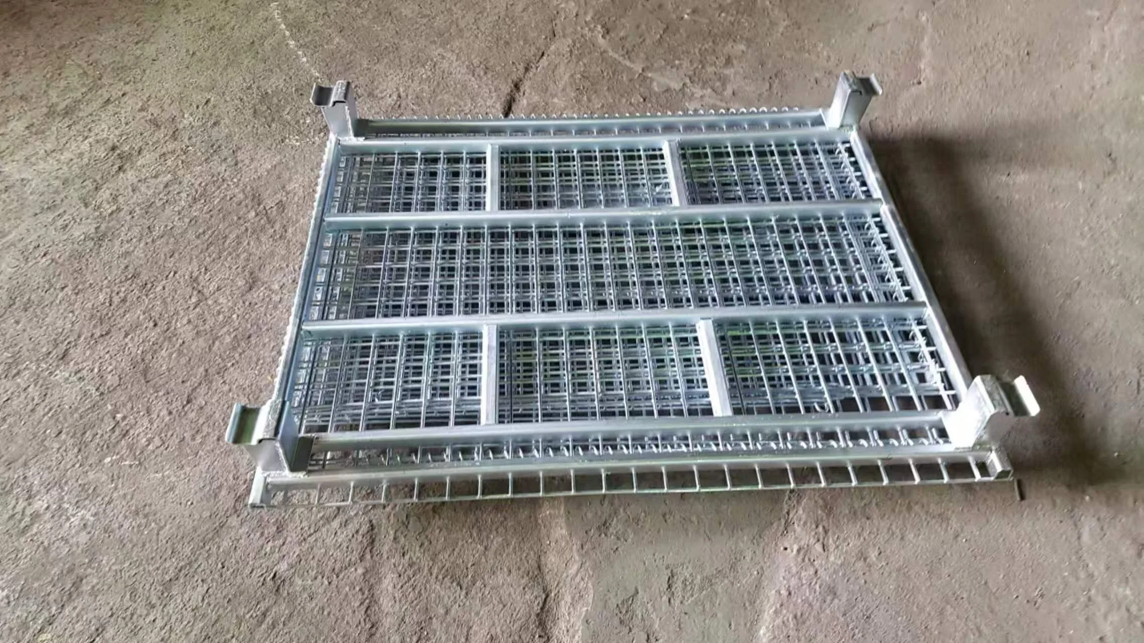 Close-up of a folded Stbox steel base showing U-channel reinforcements and heavy-duty stack feet that contribute to structural reserve.