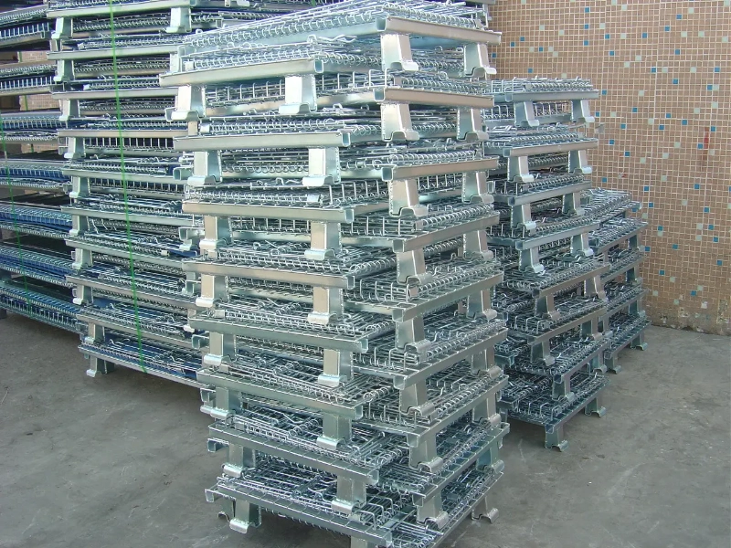 Galvanized steel wire mesh stillages stored outdoors on a concrete surface, illustrating rainwater exposure without a universal long-term corrosion guarantee.