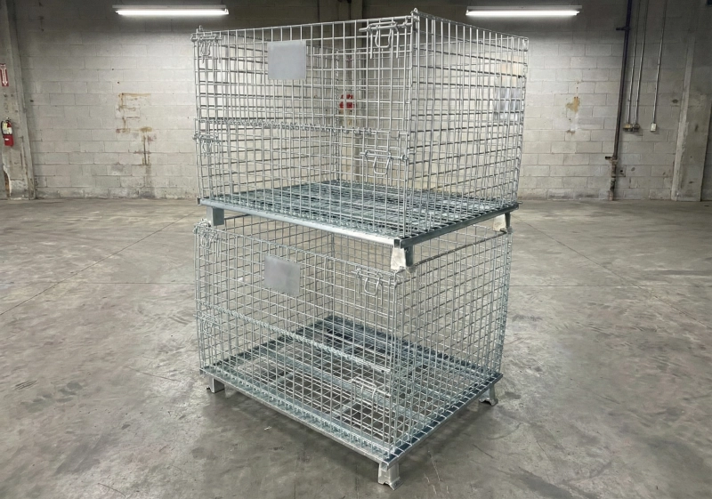 Two-high galvanized steel stillages on a concrete workshop floor; floor capacity and point loading must be checked before use.